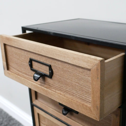 Wooden drawer with metal handle on a piece of furniture.