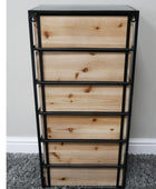 Wooden drawer unit with metal frame against a gray wall