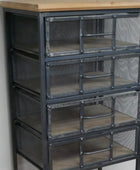Metal cabinet with glass panels and wooden top against a neutral wall