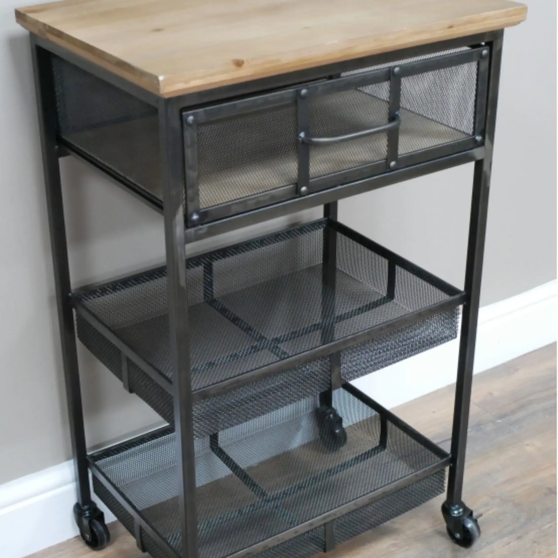 Metal utility cart with wooden top on a wooden floor.