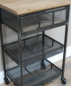 Metal utility cart with wooden top on a wooden floor.