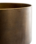 Close-up of a cylindrical metal container or planter with a warm bronze-brown metallic finish and a lighter brass-toned rim, shown against a plain white background.