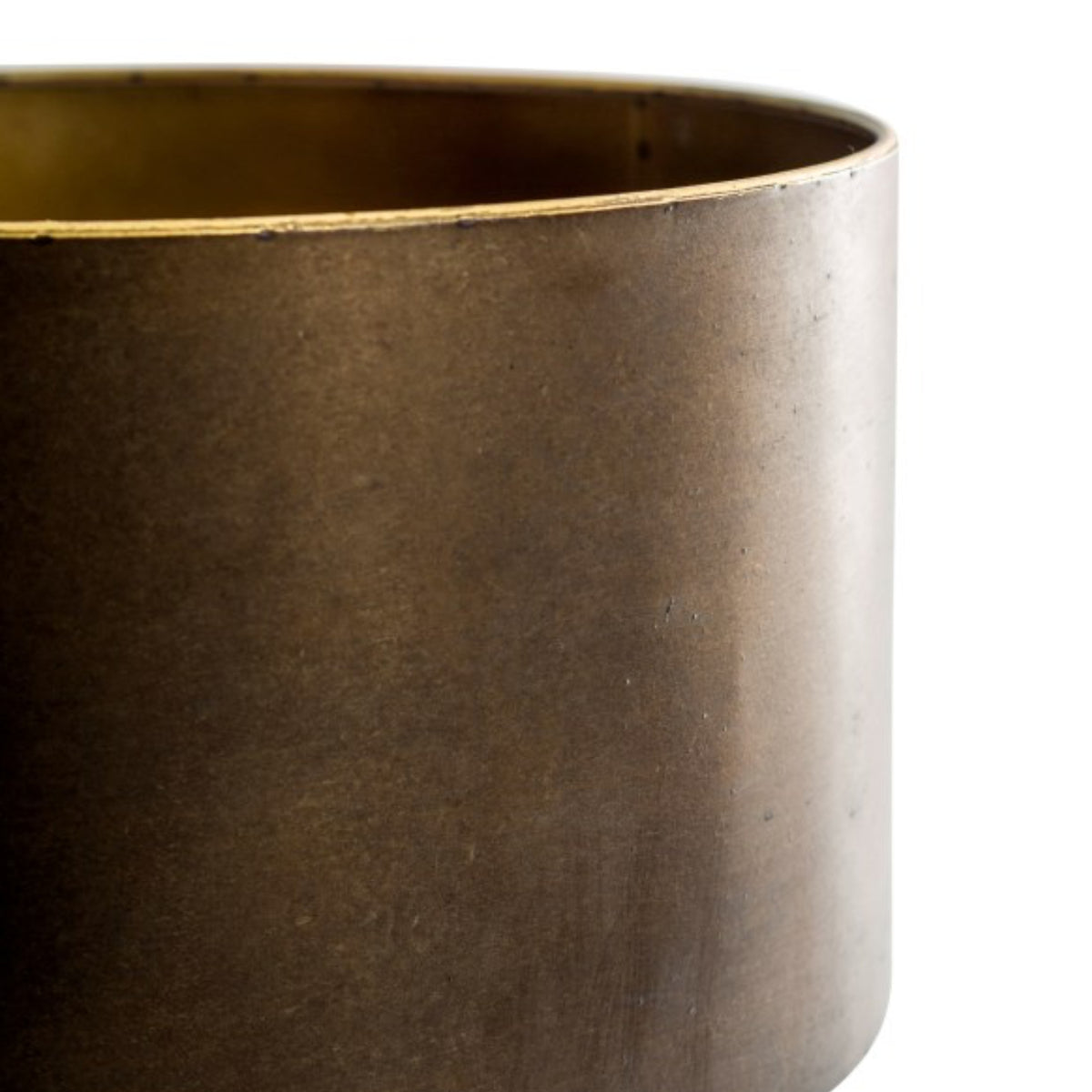 Close-up of a cylindrical metal container or planter with a warm bronze-brown metallic finish and a lighter brass-toned rim, shown against a plain white background.