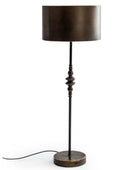 A table lamp with a dark bronze cylindrical shade, a matching dark metal stem with decorative bead details, and a round base, shown on a white background with its power cord visible.