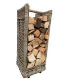Wicker firewood holder with stacked firewood on a white background