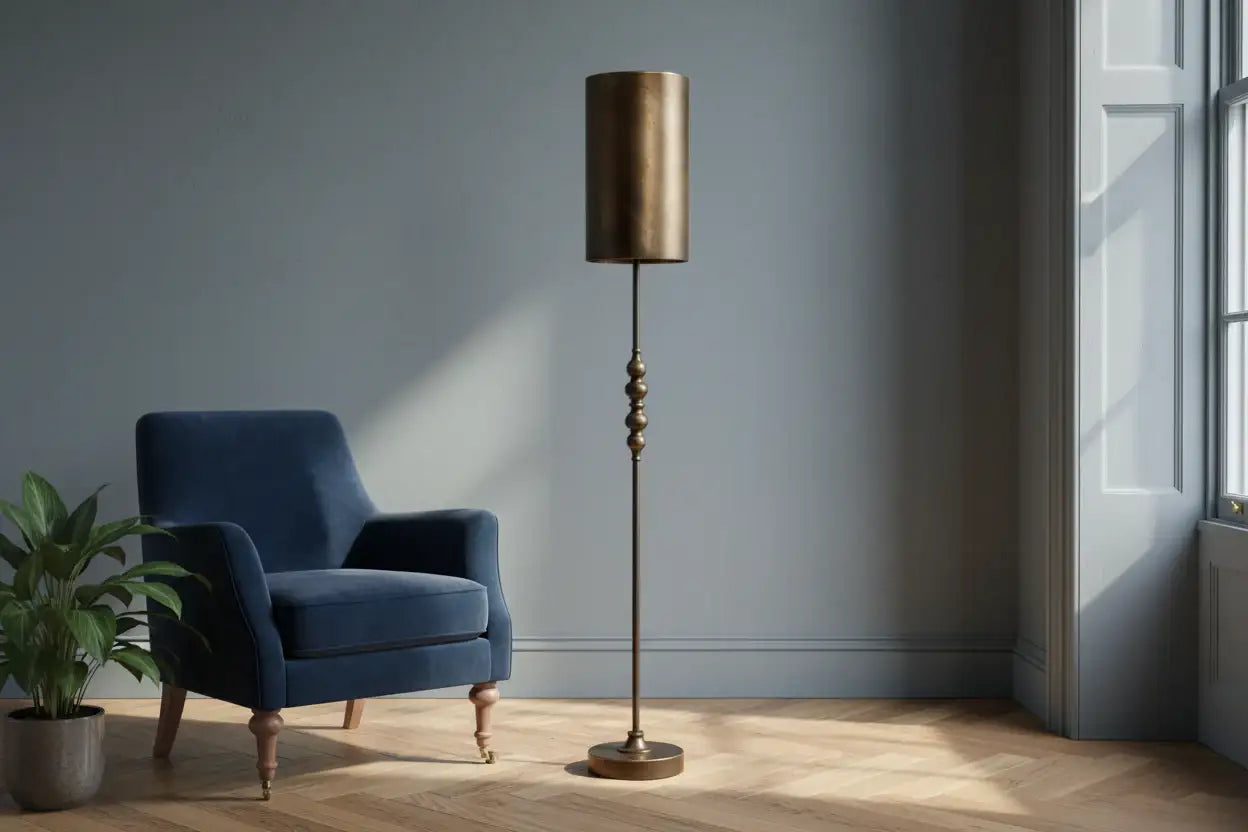 Blue armchair and standing lamp in a room with a window and plant