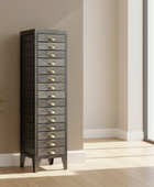Tall gray dresser with gold handles in a room with a window and plant.