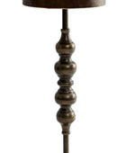 Decorative floor lamp with a textured base on a white background