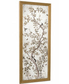 A tall, narrow framed wall art piece featuring a delicate botanical print of branches, leaves, and birds in muted brown and beige tones on an off-white background, enclosed in a gold frame.