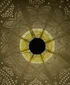 Decorative light fixture casting circular patterns on a wall
