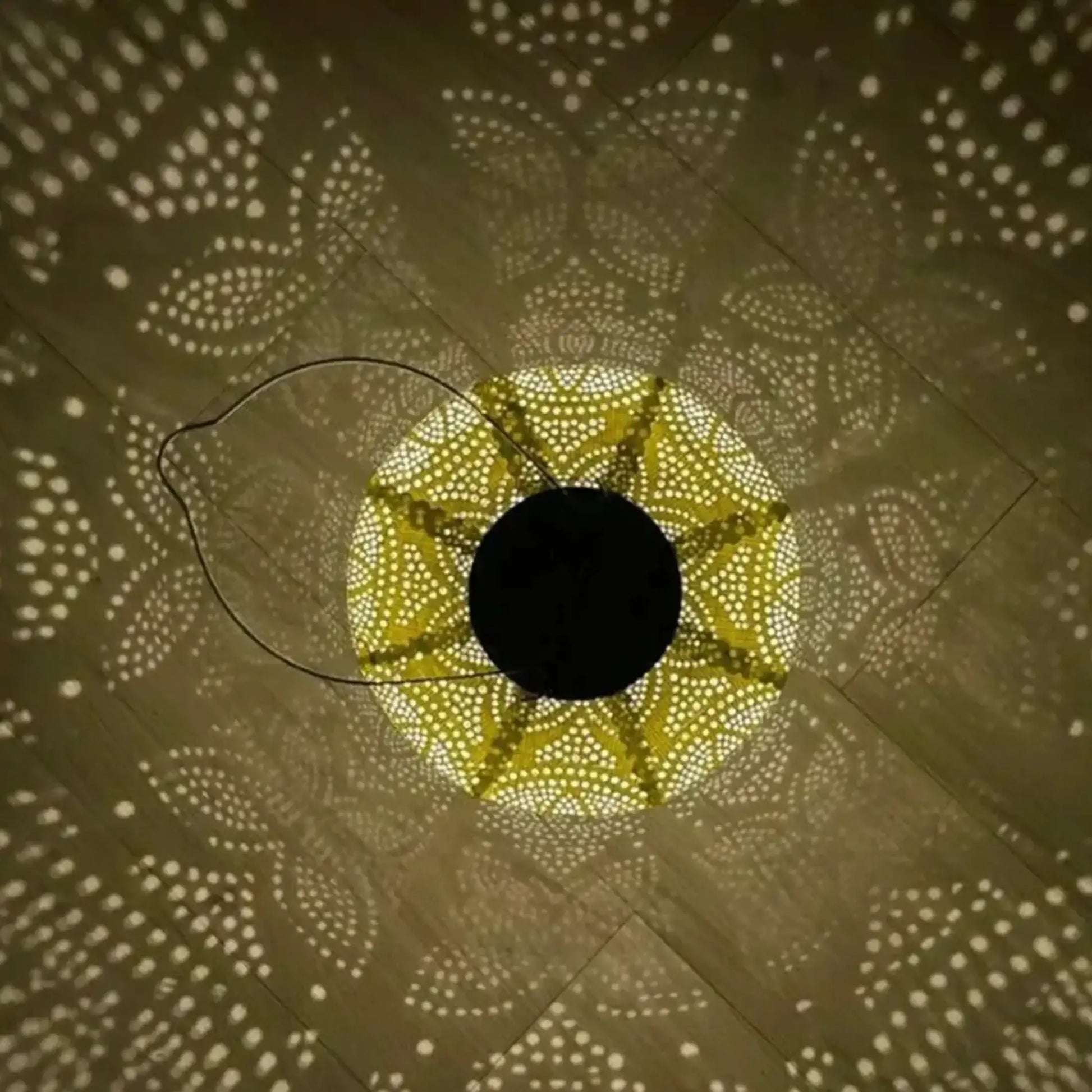 Decorative light fixture casting circular patterns on a wall