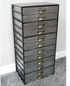 Tall metal drawer unit with multiple drawers on a gray carpet