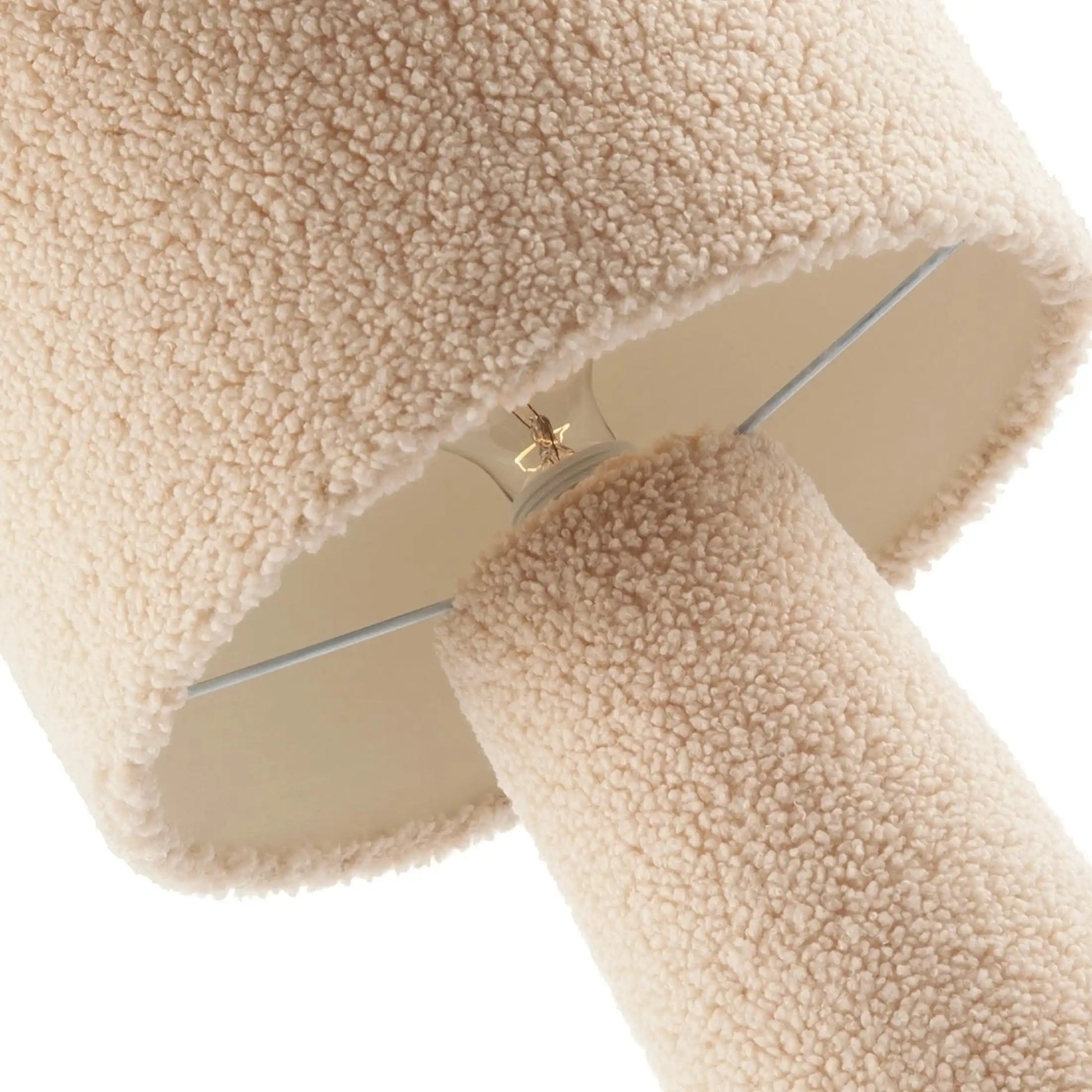 Beige sherpa fabric lampshade with a brand logo on a white background