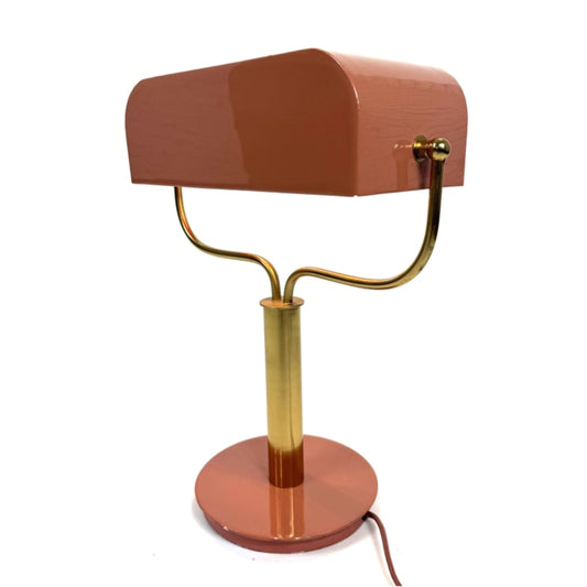 Table lamp with a brown shade and gold base on a white background