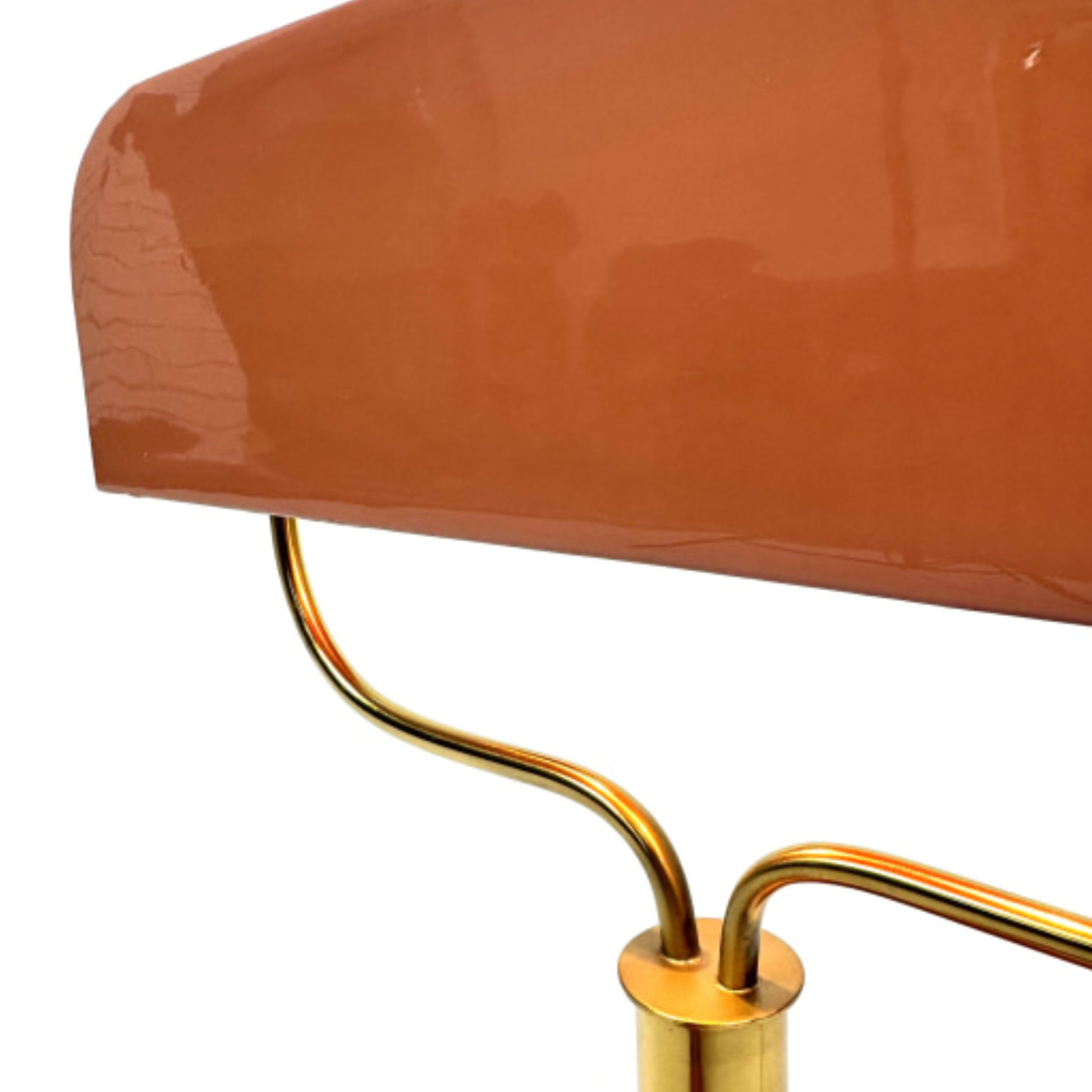 Close-up of a chair with a brown cushion and gold metal frame on a white background