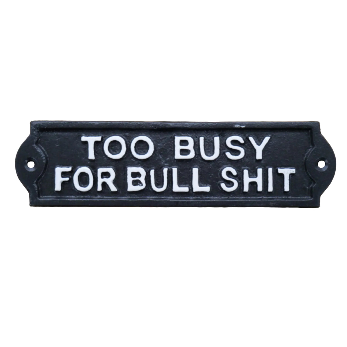A rectangular black cast iron sign with raised white lettering that reads 'TOO BUSY FOR BULL SHIT', photographed against a rustic wooden surface.