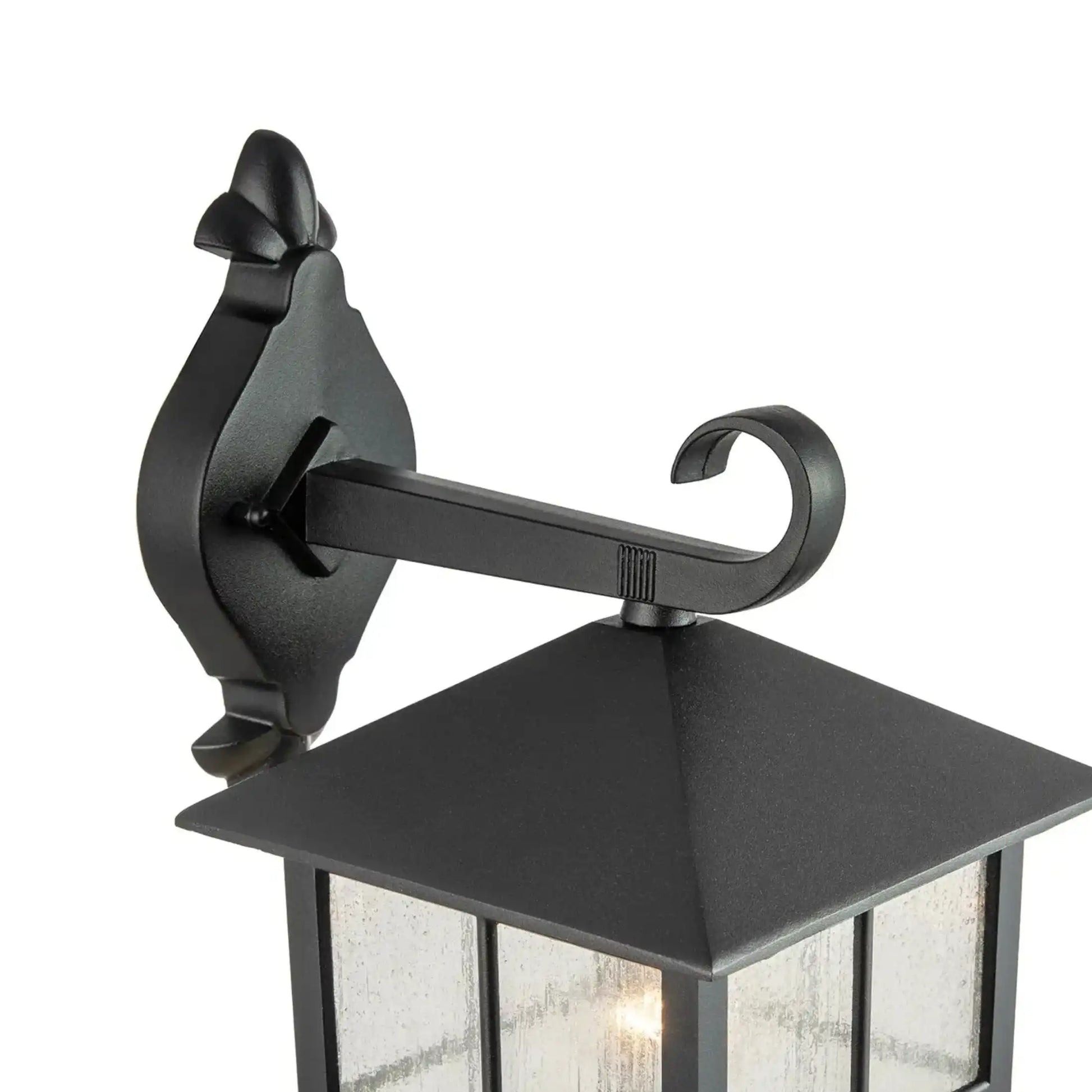 Black outdoor wall lantern with decorative arm on a white background