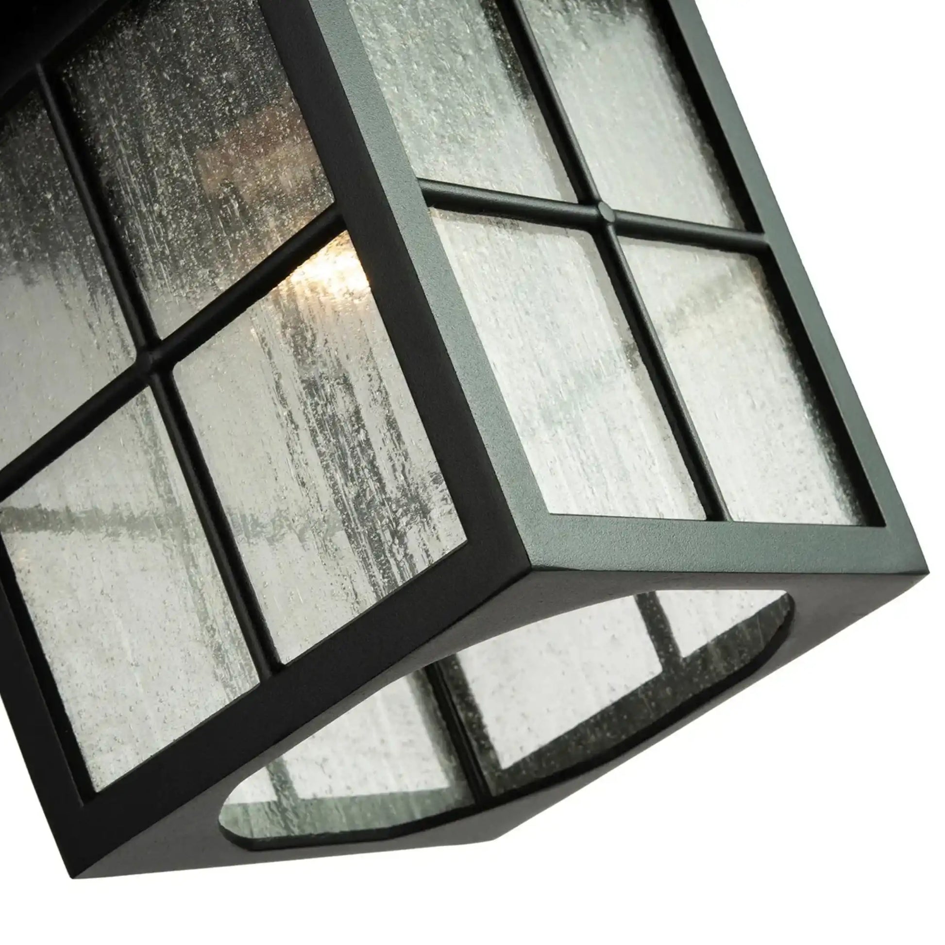 Decorative light fixture with glass panels on a white background