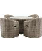 Wicker outdoor furniture set with a round table and four chairs on a white background