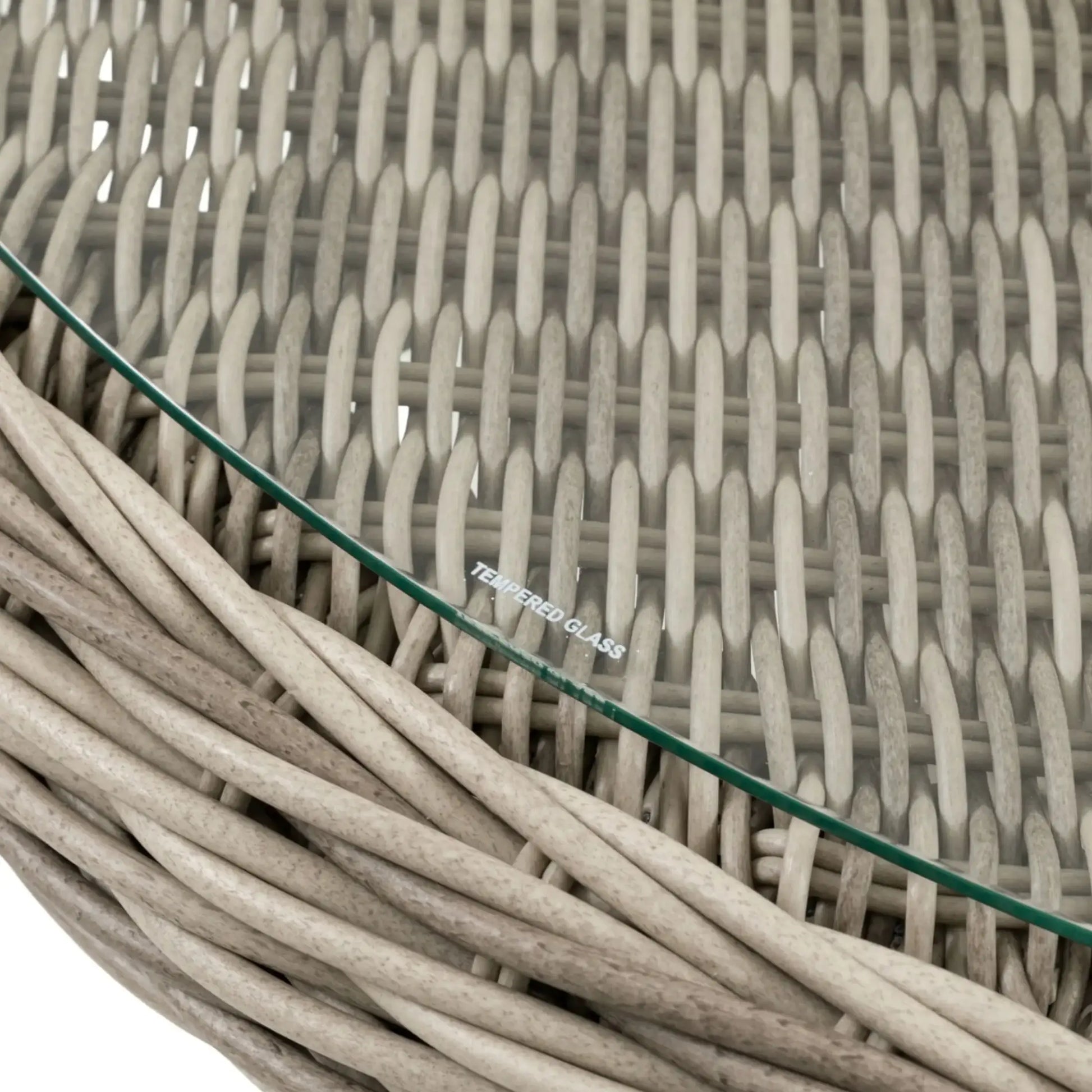 Close-up of a wicker coffee table with a glass top