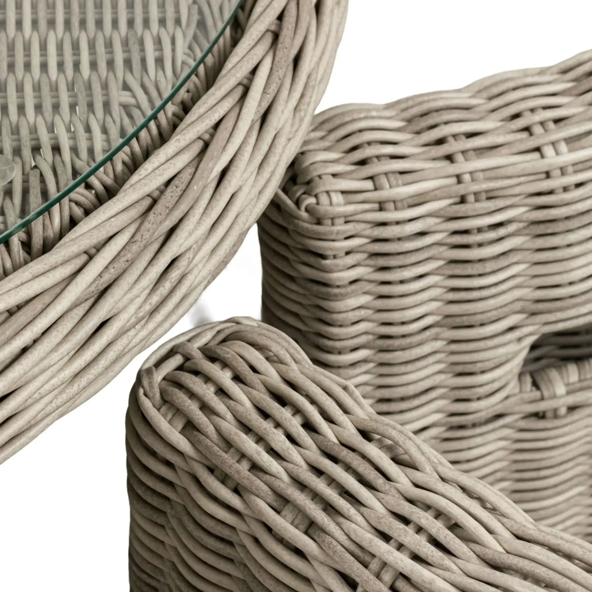 Close-up of woven wicker furniture pieces on a white background