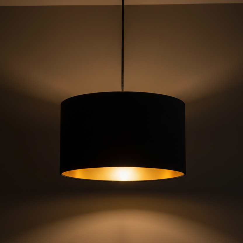 Black pendant lamp with a gold interior on a dark background