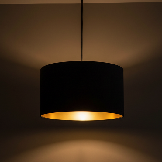 Black pendant lamp with a gold interior on a dark background