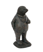 Bronze statue of a mole in formal attire on a white background