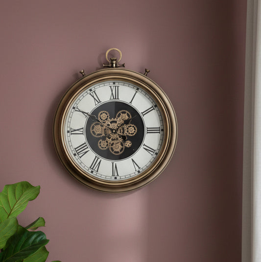 Decorative wall clock with intricate design on a pink wall