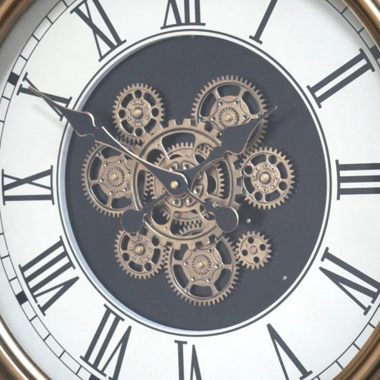 Close-up of a clock face with mechanical gears and Roman numerals