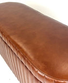 Brown leather bench with a textured surface on a white background