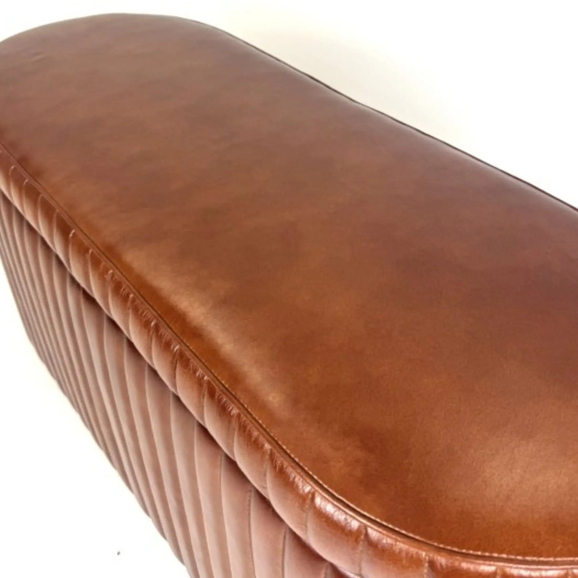 Brown leather bench with a textured surface on a white background