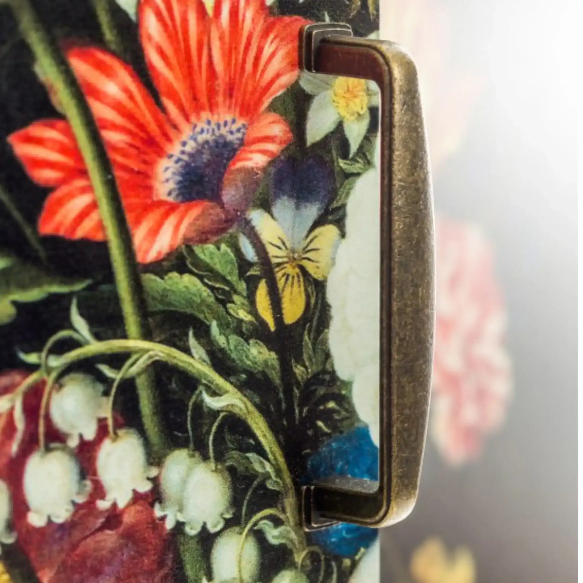Phone case with floral design featuring red, yellow, and white flowers.