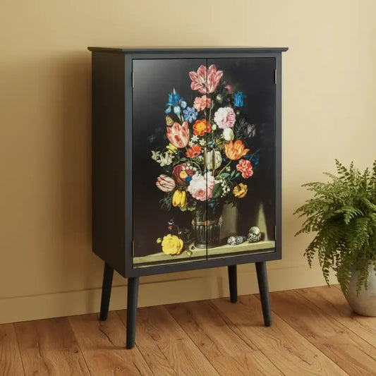 Black cabinet with floral design on a beige wall