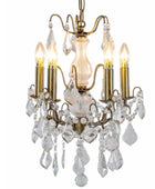 A classic six-light crystal chandelier with an antique brass/gold metal frame and clear glass teardrop pendants, shown illuminated against a white background.