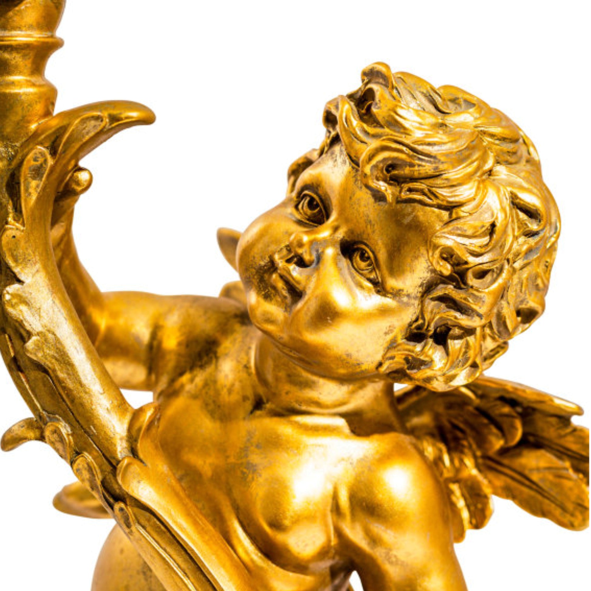 Gold cherub figurine with a white background