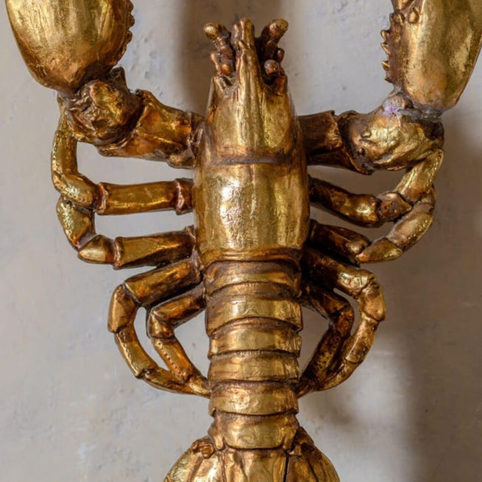 Gold lobster figurine on a white background