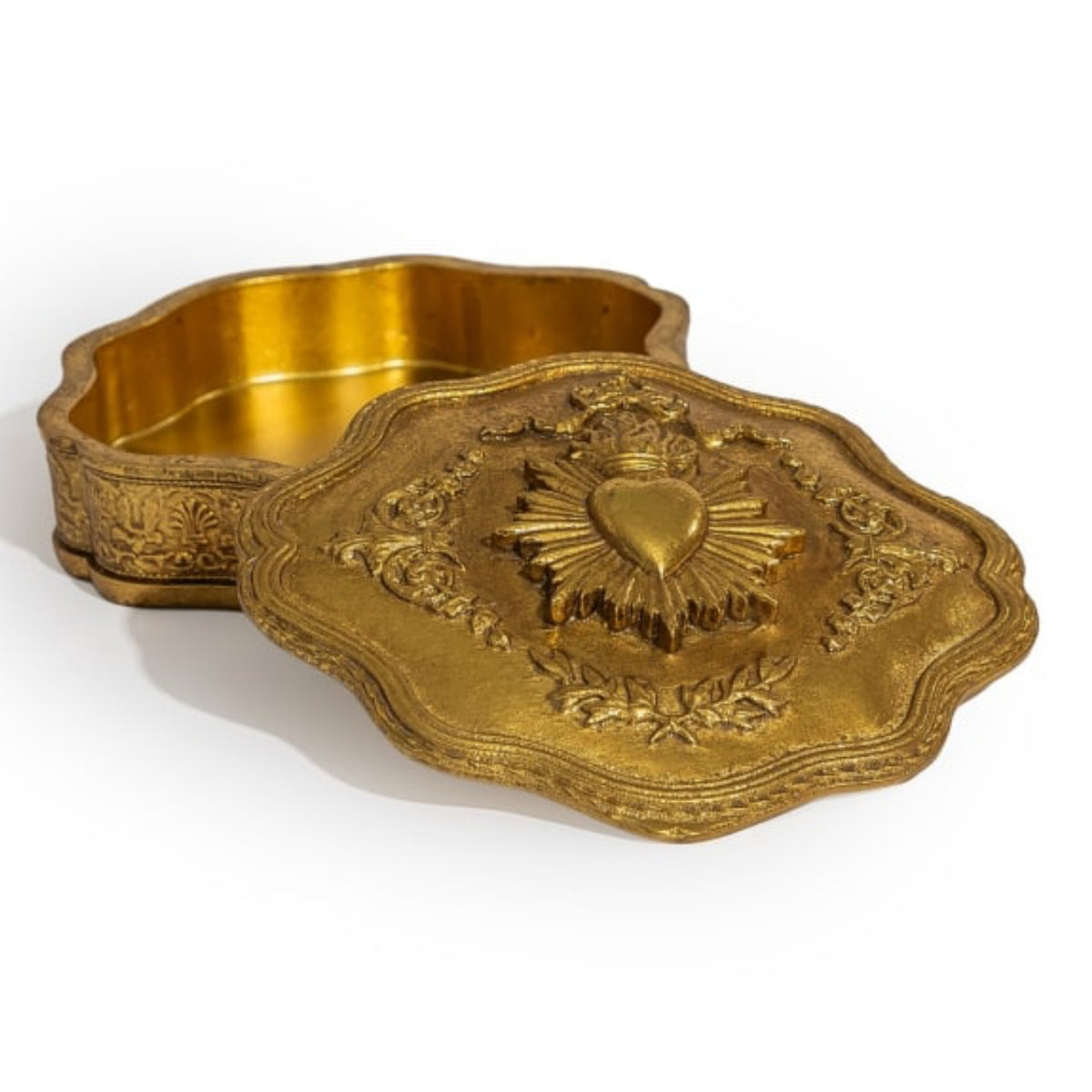 An ornate gold-toned metal box with a matching lid, featuring embossed floral scrollwork and a raised Sacred Heart design on the lid, photographed on a white background.