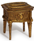 An ornate antique-style gold-finished side table or chest with carved floral details, four legs, and a hinged lid, shown on a white background.