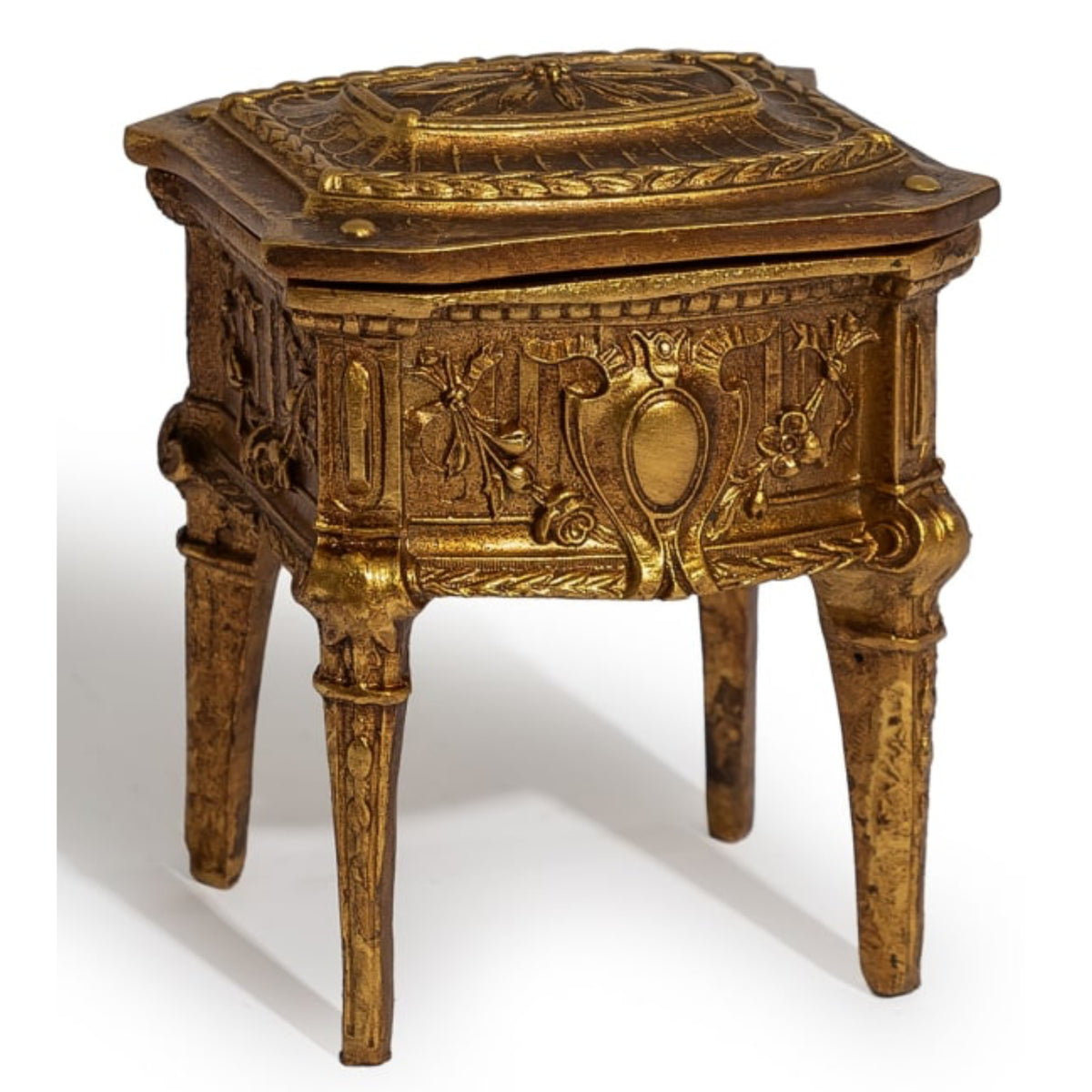 An ornate antique-style gold-finished side table or chest with carved floral details, four legs, and a hinged lid, shown on a white background.