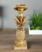 Gold pineapple-shaped candle holder on a white background