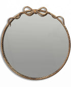Round mirror with decorative brown frame on a white background