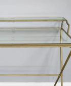 Glass console table with gold metal frame on a white background