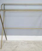 Gold metal shelf against a gray wall