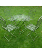 Green metal garden table and chairs set on grass