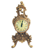 Decorative clock with gold and bronze ornate design on a white background