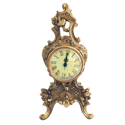 Decorative clock with gold and bronze ornate design on a white background