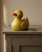 Yellow rubber duck on a wooden surface with a neutral background
