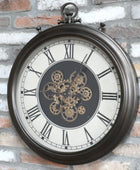 Decorative wall clock with mechanical design on a brick wall