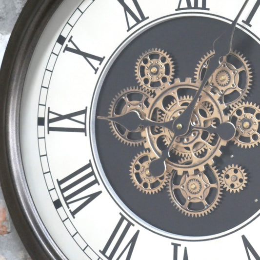 Close-up of a clock with visible gears and Roman numerals